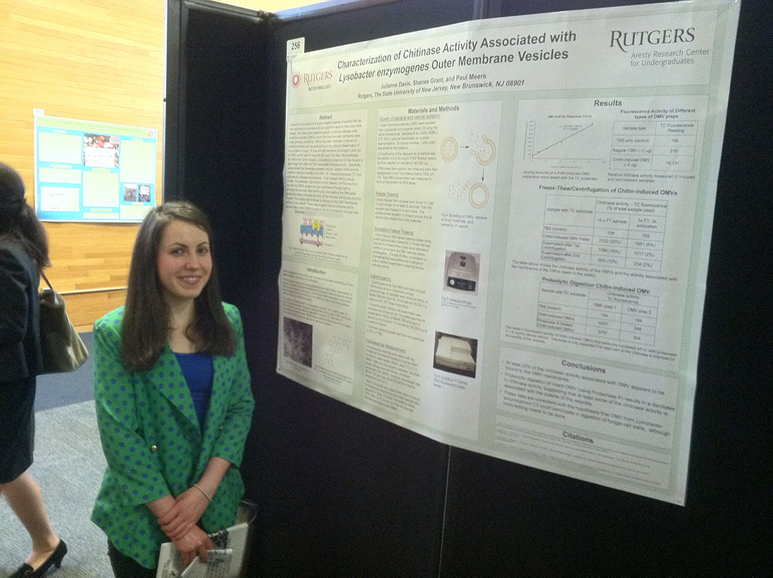 Photo of a student and her research poster.