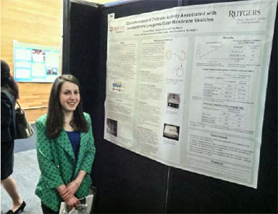 Photo of a female student presenting a poster