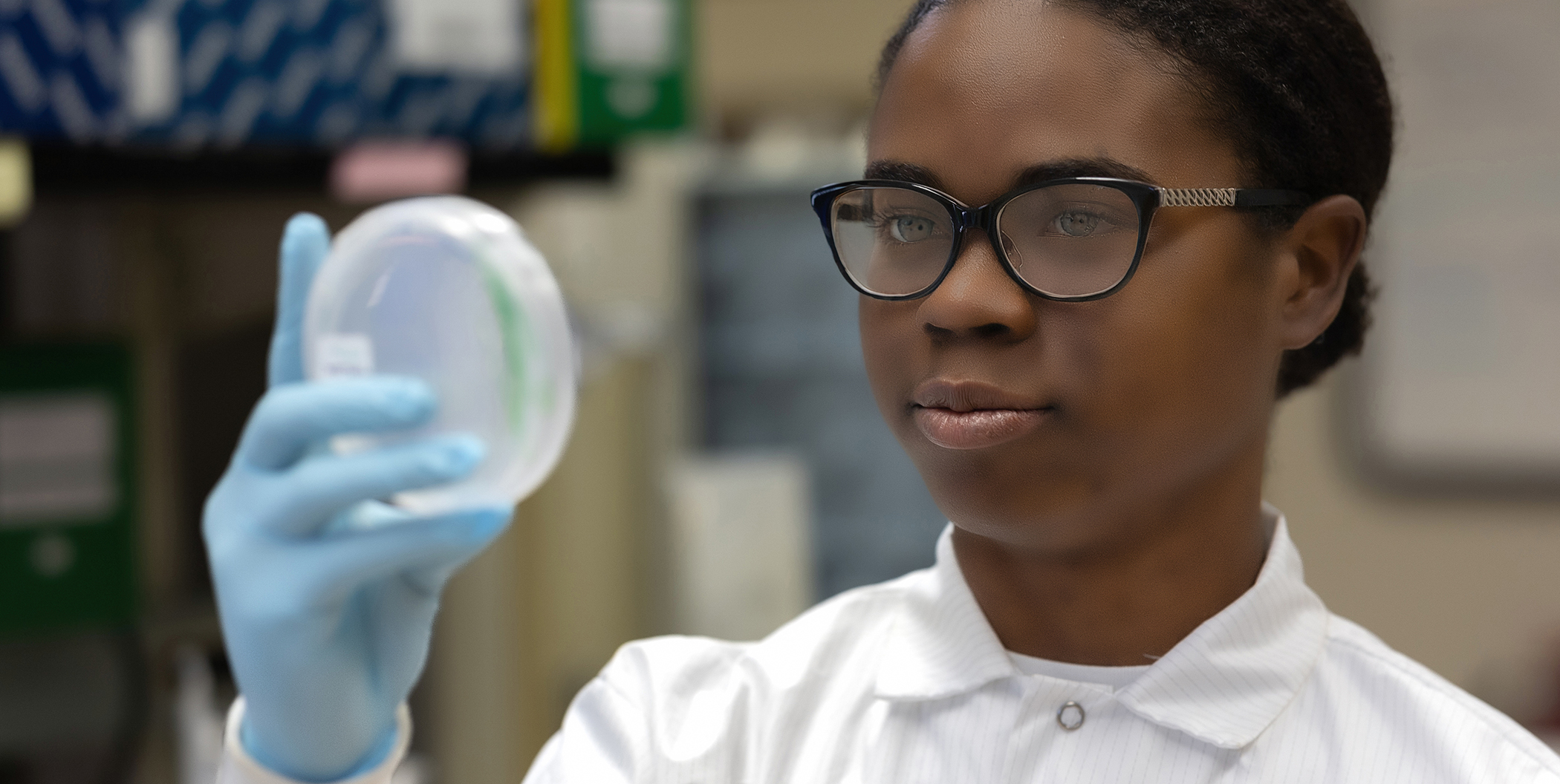 Photo of a female student holding petri dish.